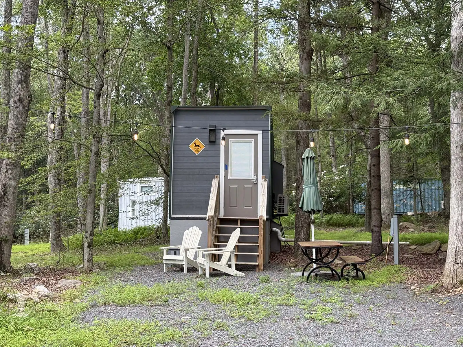 Deer Xing cabin exterior with entry steps in the Pocono woods